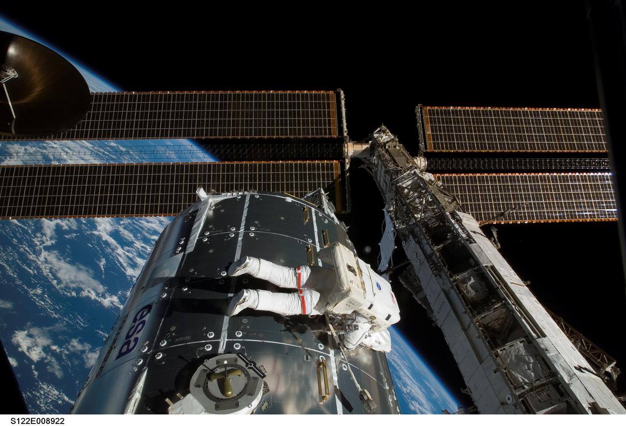 S122-E-008922 (15 Feb. 2008) --- Astronaut Rex Walheim, mission specialist, performs work on the outside of the Columbus laboratory, the newest piece of hardware on the International Space Station. Astronaut Stanley Love (out of frame), mission specialist, shared this final period of STS-122 extravehicular activity with Walheim.