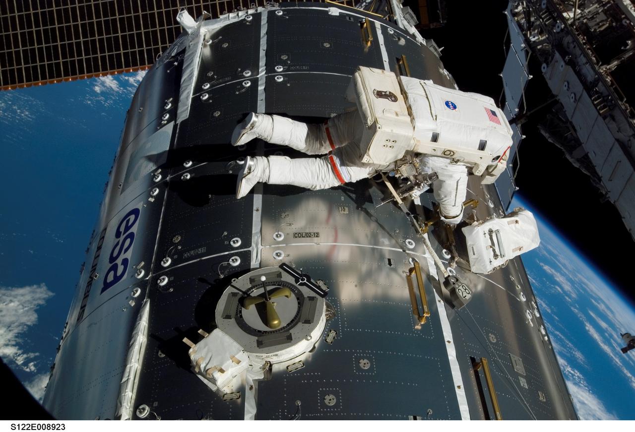 S122-E-008923 (15 Feb. 2008)  --- Astronaut Rex Walheim, mission specialist, performs work on the outside of the Columbus laboratory, the newest piece of hardware on the International Space Station.  Astronaut Stanley Love (out of frame), mission specialist, shared this final period of STS-122 extravehicular activity with Walheim.