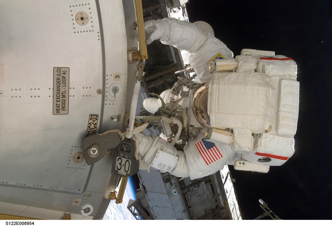 S122-E-008954 (15 Feb. 2008) --- Astronaut Rex Walheim, mission specialist, works on the new Columbus laboratory's exterior during the STS-122 Atlantis crew's final scheduled spacewalk. Astronaut Stanley Love (out of frame), mission specialist, shared this extravehicular activity with Walheim.