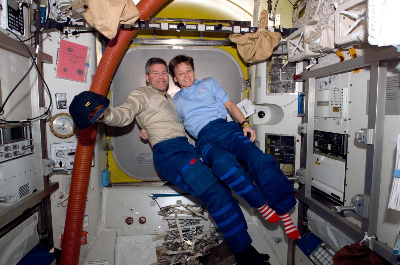 S122-E-009090 (15 Feb. 2008) --- Commanders of the STS-122 Atlantis crew and the International Space Station's expedition, respectively, astronauts Steve Frick and Peggy Whitson, give a tip of the hat to the STS-122 spacewalk team of astronauts Stanley Love and Rex Walheim, who shortly afterward ingressed the station at the completion of the mission's final spacewalk.