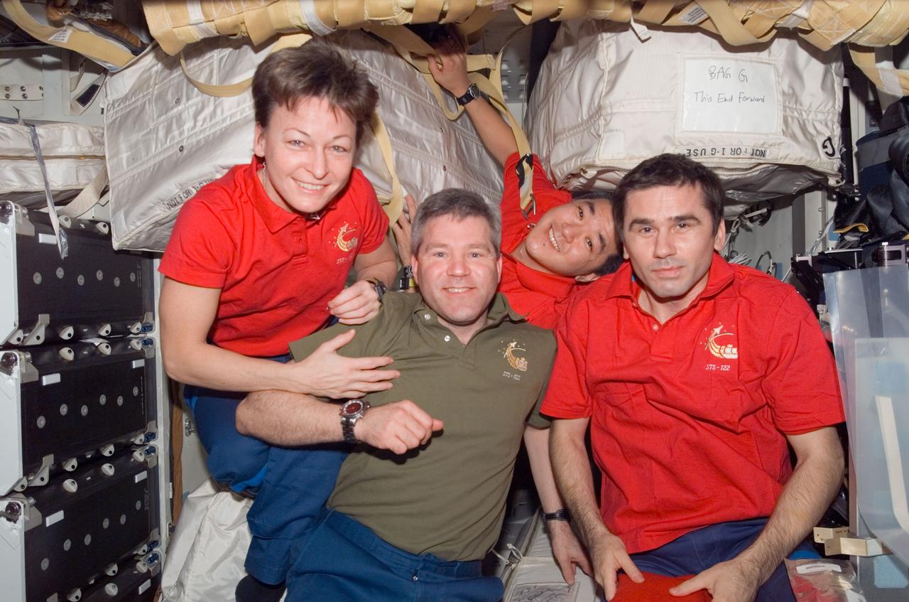 S122-E-009497 (16 Feb. 2008) --- NASA astronauts Peggy Whitson, Expedition 16 commander; Steve Frick (second left), STS-122 commander; Daniel Tani, STS-122 mission specialist; and Russian Federal Space Agency cosmonaut Yuri Malenchenko, Expedition 16 flight engineer, take a moment for a photo on the middeck of Space Shuttle Atlantis while docked with the International Space Station. Tani, who joined the station's Expedition 16 crew as flight engineer in October, is being replaced by ESA astronaut Leopold Eyharts (out of frame), who arrived at the station with the STS-122 crew.