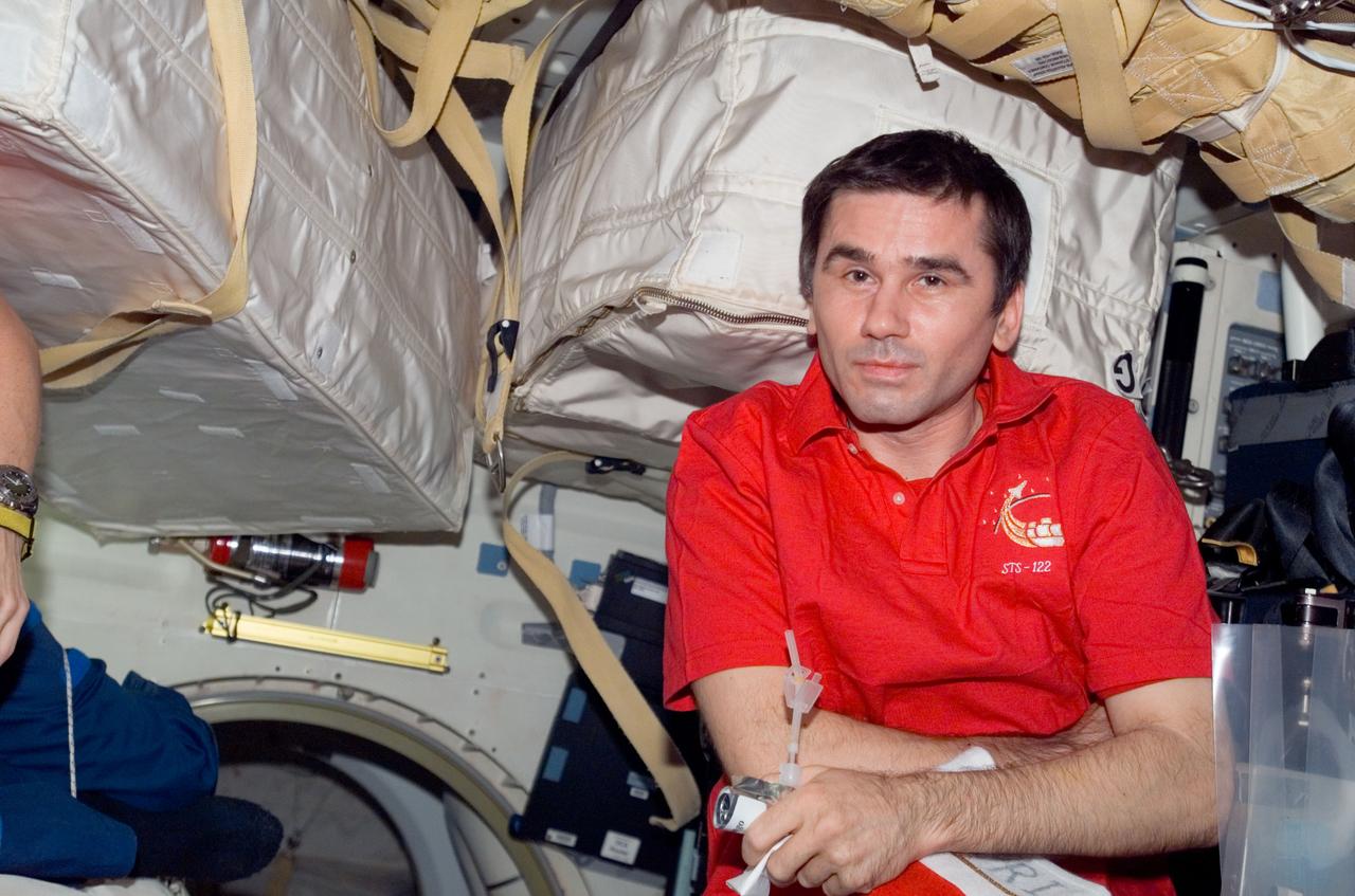 S122-E-009520 (16 Feb. 2008) --- Cosmonaut Yuri Malenchenko, Expedition 16 flight engineer representing Russia's Federal Space Agency, is pictured on the middeck of Space Shuttle Atlantis (STS-122) while docked with the International Space Station.