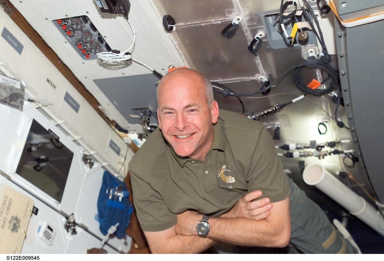 S122-E-009545 (16 Feb. 2008) --- Astronaut Alan Poindexter, STS-122 pilot, smiles for a photo as he floats on the middeck of Space Shuttle Atlantis while docked with the International Space Station.