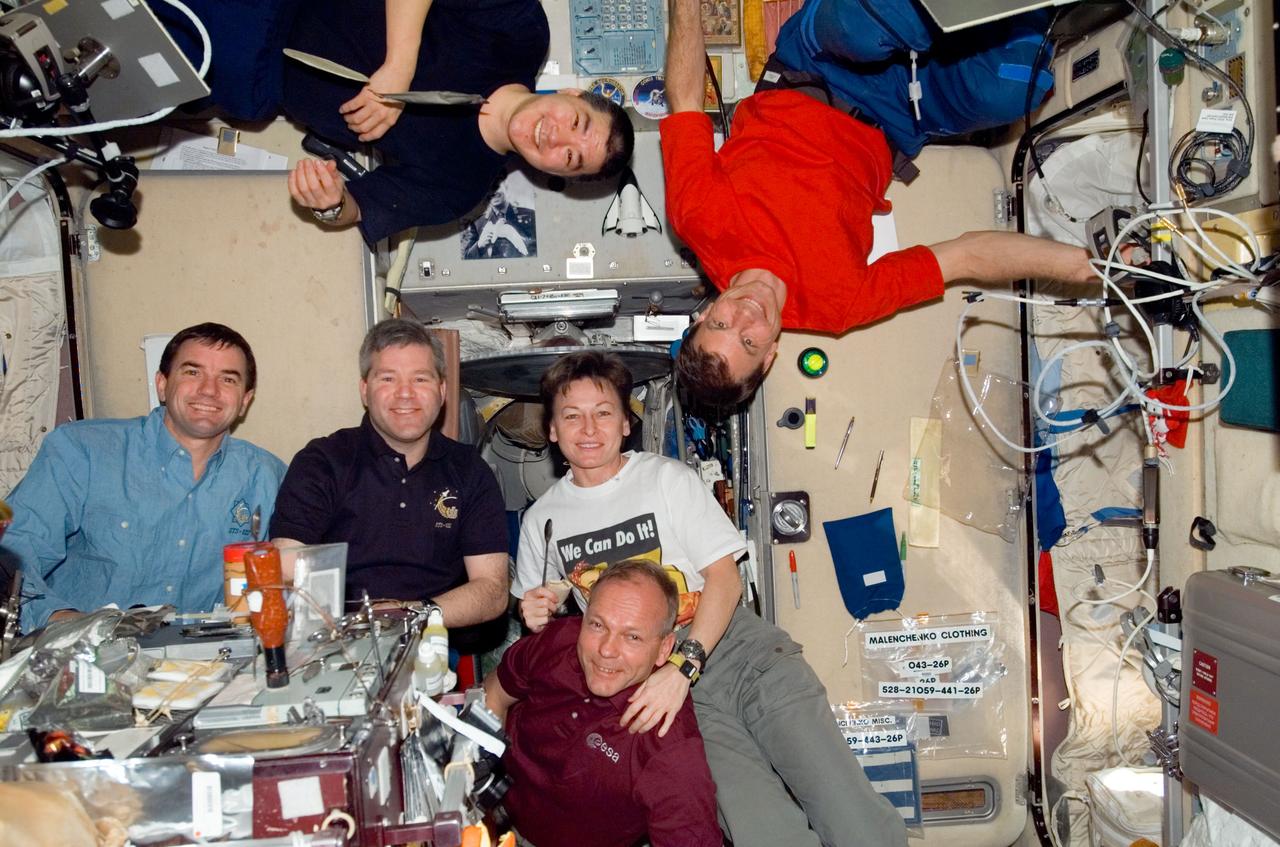 S122-E-009725 (17 Feb. 2008) --- STS-122 and Expedition 16 crewmembers share a meal at the galley in the Zvezda Service Module of the International Space Station. Pictured from the left (bottom) are NASA astronauts Rex Walheim, STS-122 mission specialist; Steve Frick, STS-122 commander; Peggy Whitson, Expedition 16 commander; and European Space Agency (ESA) astronaut Hans Schlegel, STS-122 mission specialist. Pictured from the left (top) are NASA astronauts Daniel Tani and Stanley Love, both STS-122 mission specialists.