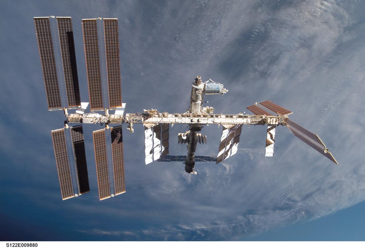 S122-E-009880 (18 Feb. 2008) --- Backdropped by a cloud-covered part of Earth, the International Space Station is seen from Space Shuttle Atlantis as the two spacecraft begin their relative separation. Earlier the STS-122 and Expedition 16 crews concluded almost nine days of cooperative work onboard the shuttle and station. Undocking of the two spacecraft occurred at 3:24 a.m. (CST) on Feb. 18, 2008.