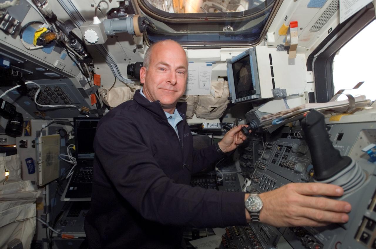 S122-E-011243 (18 Feb. 2008) --- Astronaut Alan Poindexter, STS-122 pilot, works the controls on the aft flight deck of Space Shuttle Atlantis during flight day 12 activities.