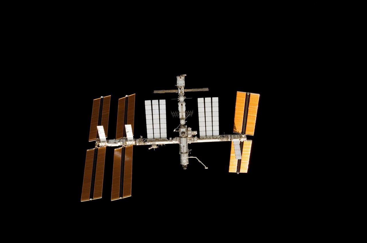 S122-E-012115 (9 Feb. 2008) --- This digital still image of the International Space Station was photographed through an overhead window on the Space Shuttle Atlantis as the two spacecraft approached each other for a Feb. 9 docking. While STS-122 astronauts were recording photos of their home for the next several days, crewmembers aboard the ISS were clicking images of the shuttle, with the primary focus being on its thermal protection system.