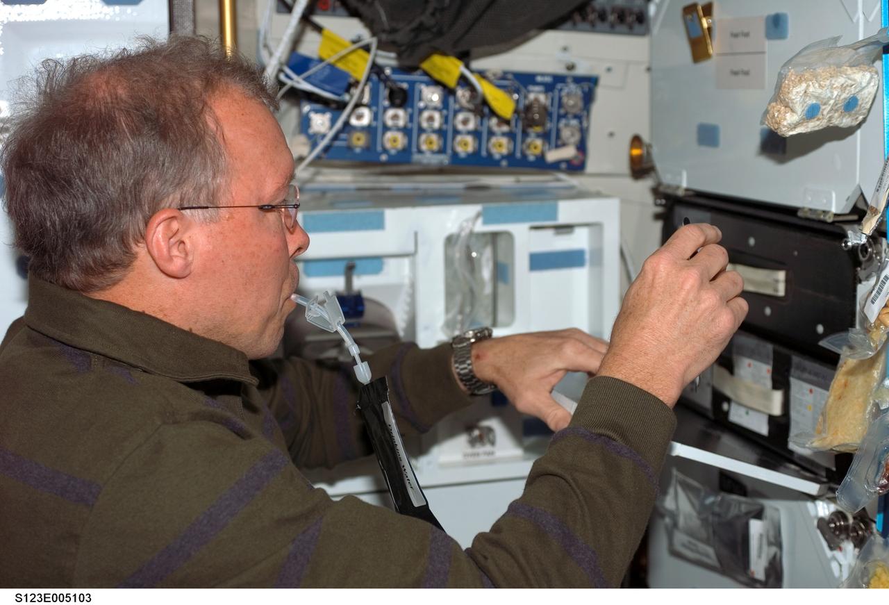 S123-E-005103 (11 March 2008) --- Astronaut Dominic Gorie, STS-123 commander, drinks a beverage at the galley on the middeck of Space Shuttle Endeavour late in flight day one activities.