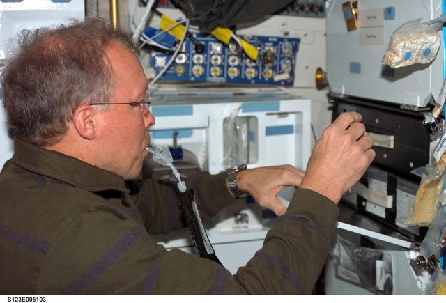 NASA image: Gorie enjoys drink in the MDDK during STS-123 mission