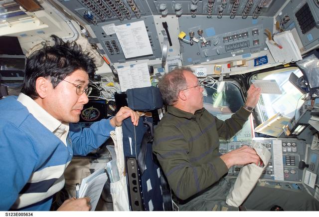 NASA image: Gorie looks at crew procedures in the aft FD during STS-123 mission