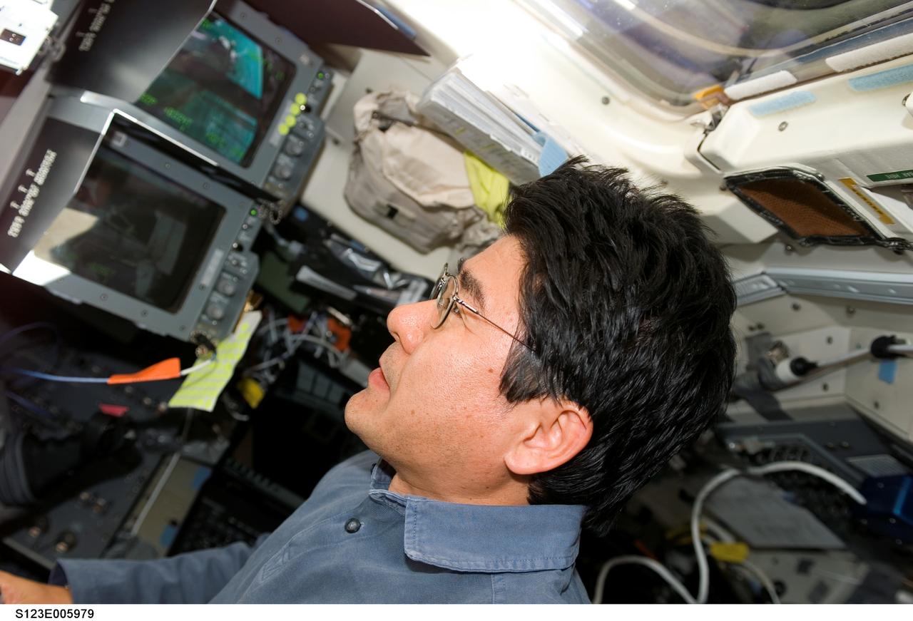 S123-E-005979 (14 March 2008) --- Japan Aerospace Exploration Agency (JAXA) astronaut Takao Doi, STS-123 mission specialist, works on the flight deck of Space Shuttle Endeavour while docked with the International Space Station.