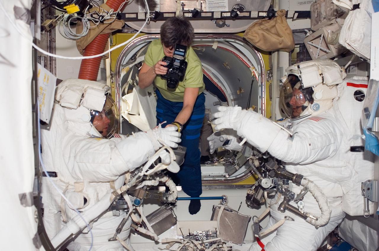 S123-E-006031 (14 March 2008) --- As the mission's first session of extravehicular activity (EVA) draws to a close, astronaut Peggy Whitson, Expedition 16 commander, photographs the Extravehicular Mobility Unit (EMU) gloves worn by astronauts Garrett Reisman (left), Expedition 16 flight engineer; and Rick Linnehan, STS-123 mission specialist, in the Quest Airlock of the International Space Station.