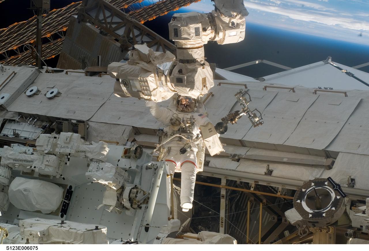 S123-E-006075 (13/14 March 2008) --- Astronaut Rick Linnehan, STS-123 mission specialist, participates in the mission's first scheduled session of extravehicular activity (EVA) as construction and maintenance continue on the International Space Station. During the seven-hour and one-minute spacewalk, Linnehan and astronaut Garrett Reisman (out of frame), Expedition 16 flight engineer, prepared the Japanese logistics module-pressurized section (JLP) for removal from Space Shuttle Endeavour's payload bay; opened the Centerline Berthing Camera System on top of the Harmony module; removed the Passive Common Berthing Mechanism and installed both the Orbital Replacement Unit (ORU) tool change out mechanisms on the Canadian-built Dextre robotic system, the final element of the station's Mobile Servicing System.