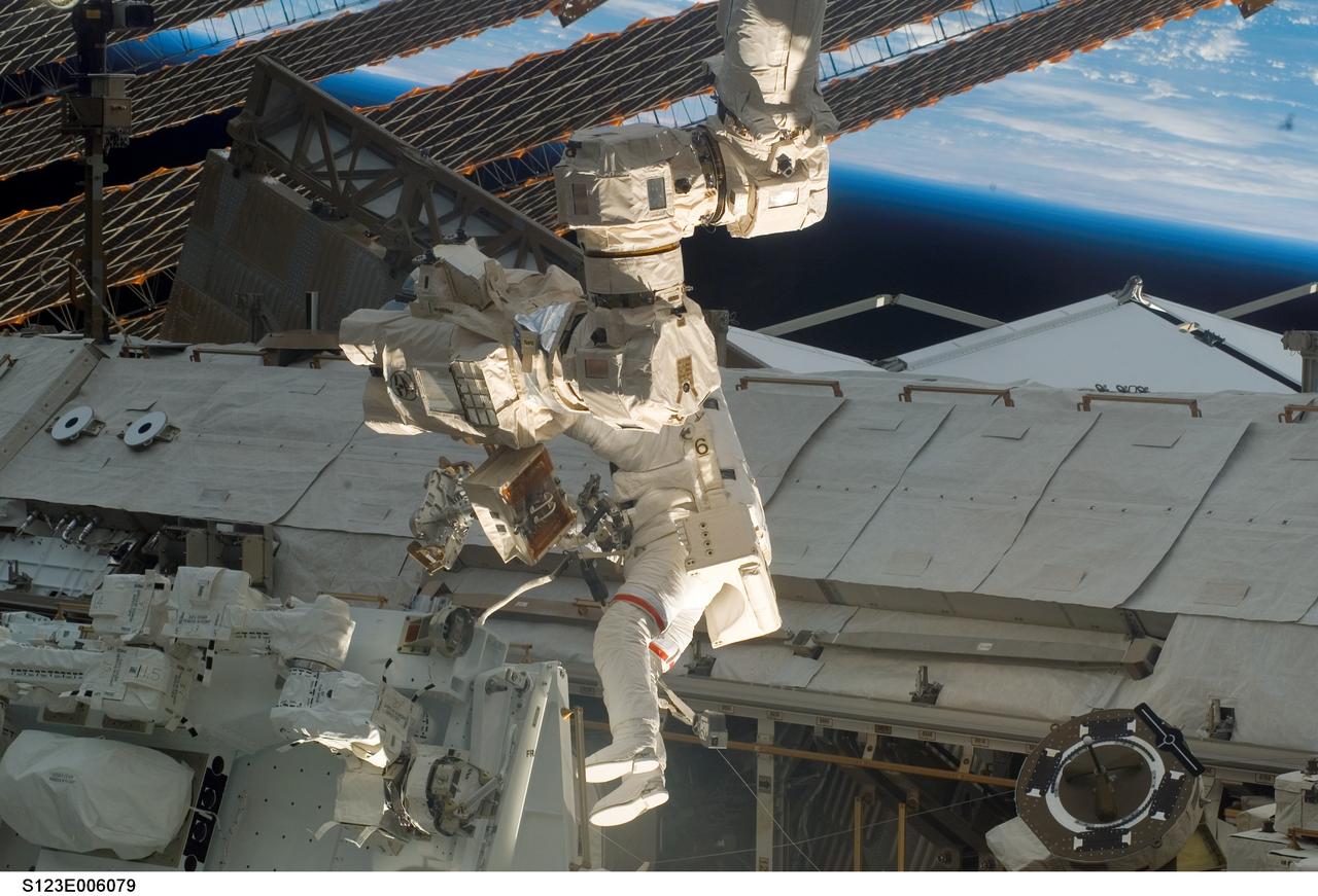 S123-E-006079 (13/14 March 2008) --- Astronaut Rick Linnehan, STS-123 mission specialist, participates in the mission's first scheduled session of extravehicular activity (EVA) as construction and maintenance continue on the International Space Station. During the seven-hour and one-minute spacewalk, Linnehan and astronaut Garrett Reisman (out of frame), Expedition 16 flight engineer, prepared the Japanese logistics module-pressurized section (JLP) for removal from Space Shuttle Endeavour's payload bay; opened the Centerline Berthing Camera System on top of the Harmony module; removed the Passive Common Berthing Mechanism and installed both the Orbital Replacement Unit (ORU) tool change out mechanisms on the Canadian-built Dextre robotic system, the final element of the station's Mobile Servicing System.