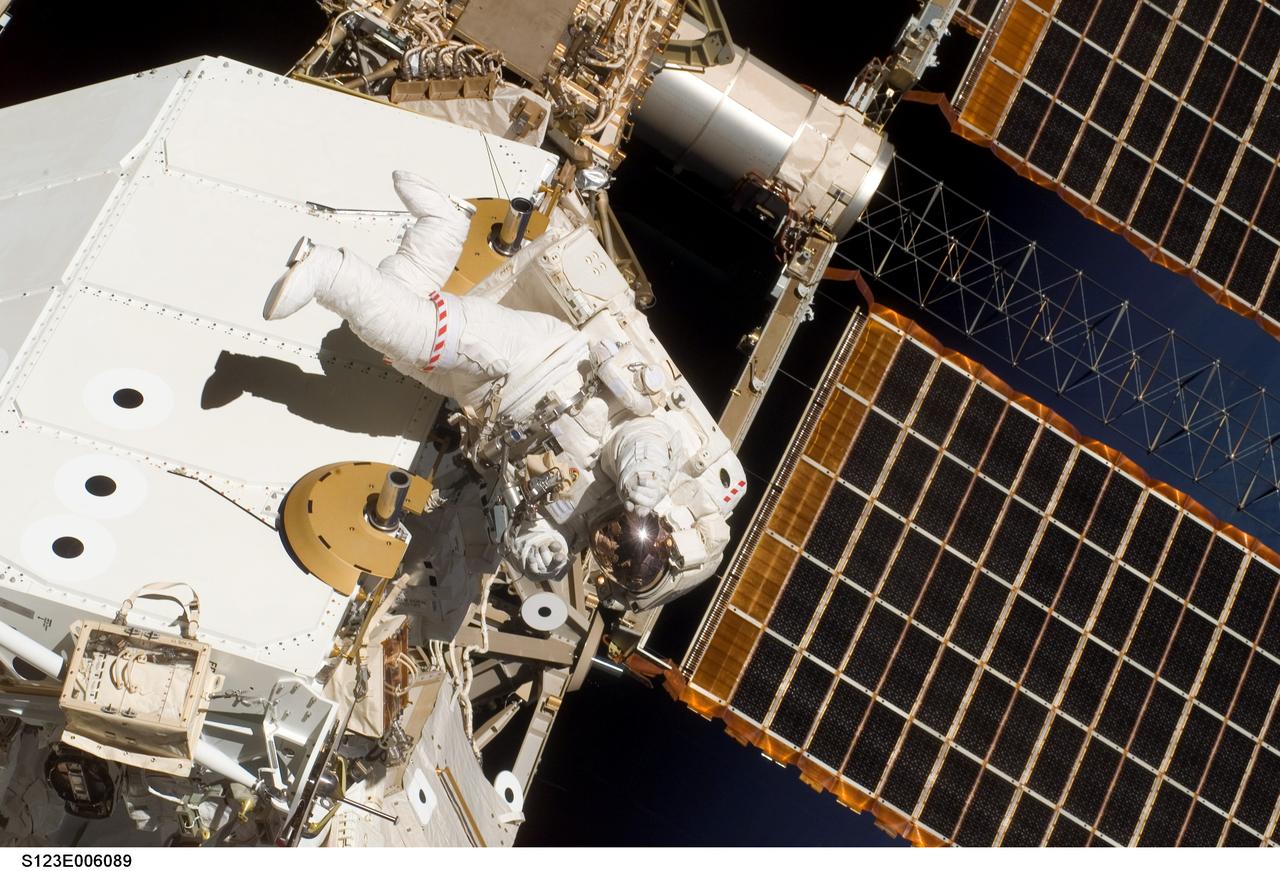 S123-E-006089 (13/14 March 2008) --- Astronaut Garrett Reisman, Expedition 16 flight engineer, participates in the mission's first scheduled session of extravehicular activity (EVA) as construction and maintenance continue on the International Space Station. During the seven-hour and one-minute spacewalk, Reisman and astronaut Rick Linnehan (out of frame), STS-123 mission specialist, prepared the Japanese logistics module-pressurized section (JLP) for removal from Space Shuttle Endeavour's payload bay; opened the Centerline Berthing Camera System on top of the Harmony module; removed the Passive Common Berthing Mechanism and installed both the Orbital Replacement Unit (ORU) tool change out mechanisms on the Canadian-built Dextre robotic system, the final element of the station's Mobile Servicing System.