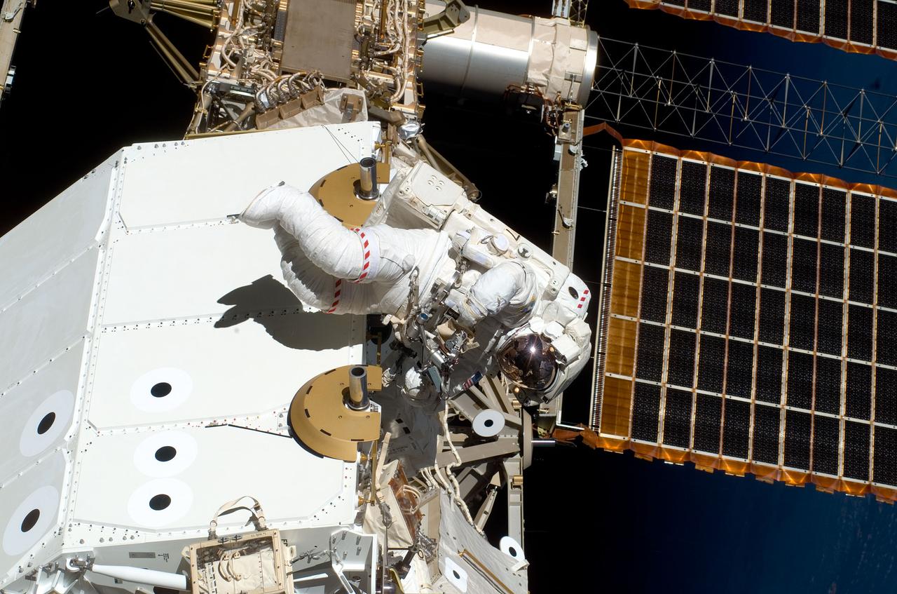 S123-E-006090 (13/14 March 2008) --- Astronaut Garrett Reisman, Expedition 16 flight engineer, participates in the mission's first scheduled session of extravehicular activity (EVA) as construction and maintenance continue on the International Space Station. During the seven-hour and one-minute spacewalk, Reisman and astronaut Rick Linnehan (out of frame), STS-123 mission specialist, prepared the Japanese logistics module-pressurized section (JLP) for removal from Space Shuttle Endeavour's payload bay; opened the Centerline Berthing Camera System on top of the Harmony module; removed the Passive Common Berthing Mechanism and installed both the Orbital Replacement Unit (ORU) tool change out mechanisms on the Canadian-built Dextre robotic system, the final element of the station's Mobile Servicing System.