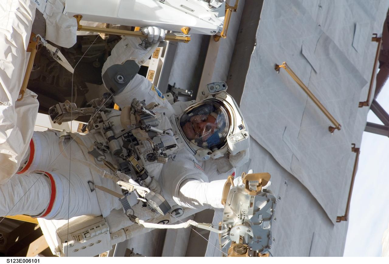 S123-E-006101 (13/14 March 2008) --- Astronaut Rick Linnehan, STS-123 mission specialist, participates in the mission's first scheduled session of extravehicular activity (EVA) as construction and maintenance continue on the International Space Station. During the seven-hour and one-minute spacewalk, Linnehan and astronaut Garrett Reisman (out of frame), Expedition 16 flight engineer, prepared the Japanese logistics module-pressurized section (JLP) for removal from Space Shuttle Endeavour's payload bay; opened the Centerline Berthing Camera System on top of the Harmony module; removed the Passive Common Berthing Mechanism and installed both the Orbital Replacement Unit (ORU) tool change out mechanisms on the Canadian-built Dextre robotic system, the final element of the station's Mobile Servicing System.