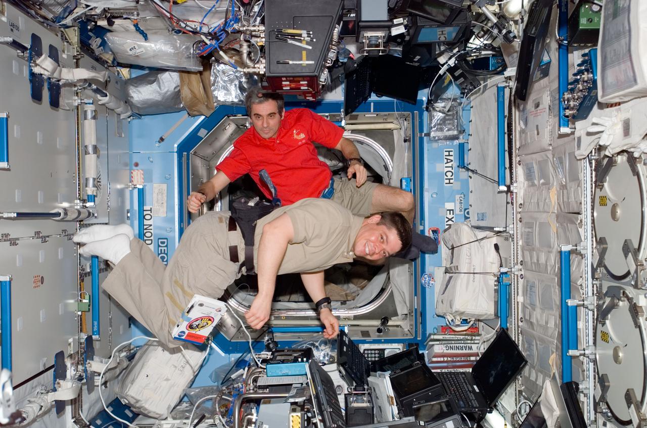 S123-E-006253 (15 March 2008) --- NASA astronaut Robert L. Behnken (bottom) and European Space Agency (ESA) astronaut Leopold Eyharts, both STS-123 mission specialists, take a moment for a photo while they work the controls of the space station's robotic Canadarm2 in the Destiny laboratory of the International Space Station while Space Shuttle Endeavour is docked with the station.