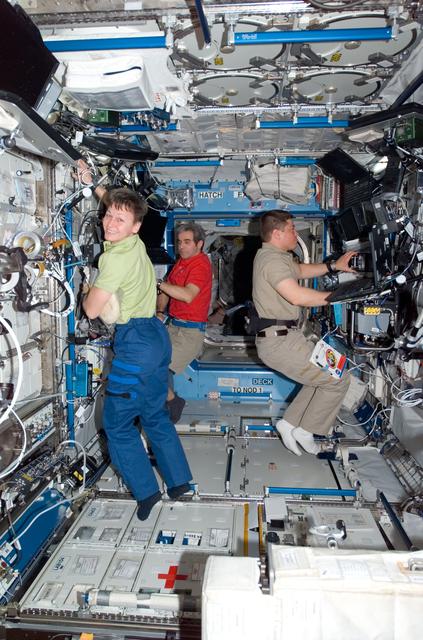 NASA image: STS-123 Crewmembers work in the U.S. Laboratory during STS-123 / Expedition 16 Joint Operations