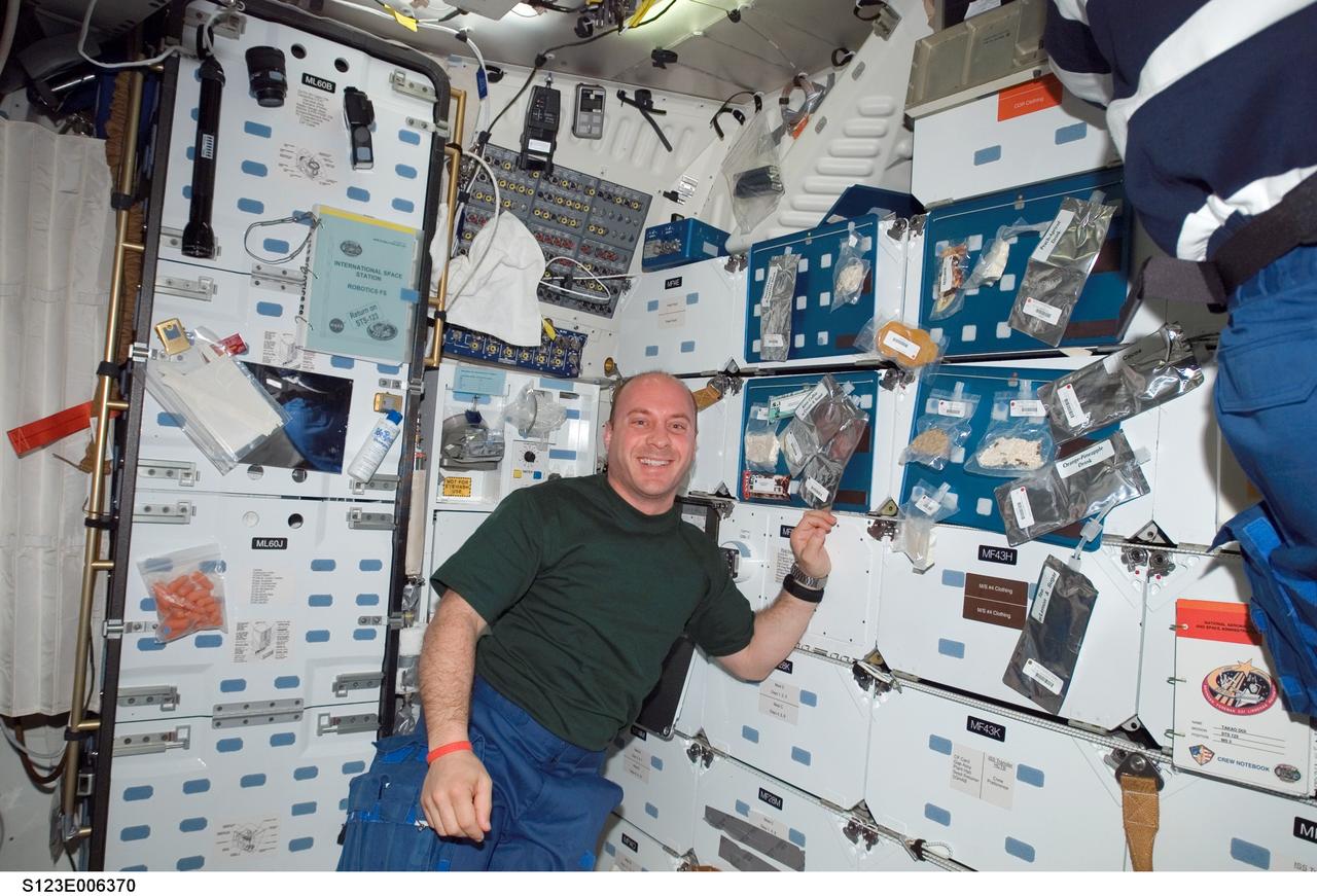 S123-E-006370 (15 March 2008) --- NASA astronaut Garrett Reisman, Expedition 16 flight engineer, smiles for a photo at the galley on the middeck of Space Shuttle Endeavour while docked with the International Space Station.