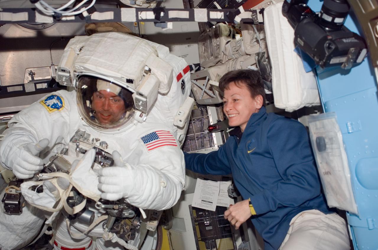 S123-E-006420 (16 March 2008) --- Attired in his Extravehicular Mobility Unit (EMU) spacesuit, astronaut Mike Foreman, STS-123 mission specialist, gives a "thumbs-up" signal in the Quest Airlock of the International Space Station as the mission's second scheduled session of extravehicular activity (EVA) draws to a close. Astronaut Peggy Whitson, Expedition 16 commander, assisted Foreman.