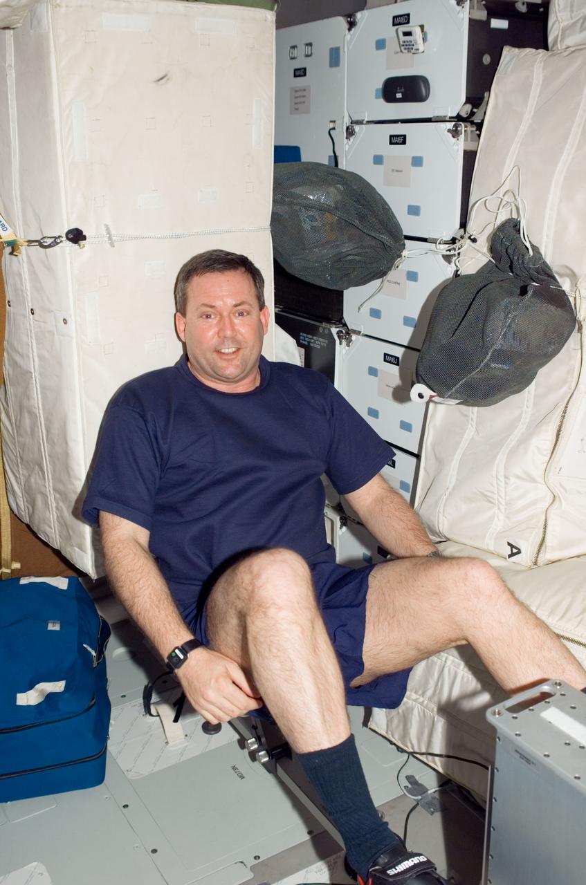 S123-E-006485 (12 March 2008) --- Astronaut Mike Foreman, STS-123 mission specialist, exercises on a bicycle ergometer on the middeck of the Space Shuttle Endeavour while docked with the International Space Station.