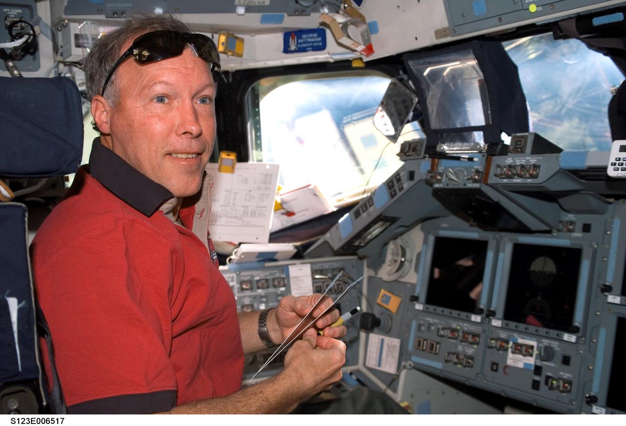 S123-E-006517 (13 March 2008) --- Astronaut Dominic Gorie, STS-123 commander, works at the commander's station on the flight deck of Space Shuttle Endeavour while docked with the International Space Station.