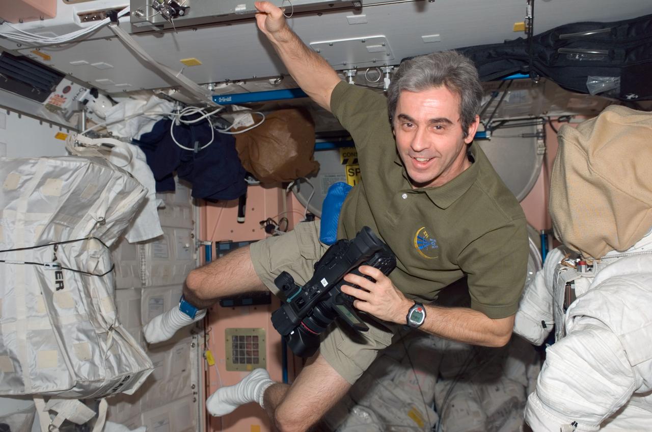 S123-E-006607 (13 March 2008) --- European Space Agency (ESA) astronaut Leopold Eyharts, STS-123 mission specialist, holds a video camera in the Unity node of the International Space Station while Space Shuttle Endeavour is docked with the station.