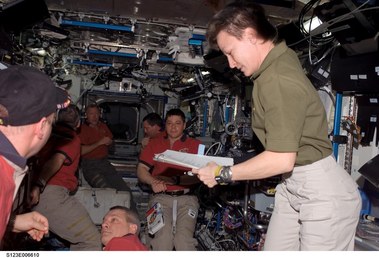 S123-E-006610 (13 March 2008) --- STS-123 and Expedition 16 crewmembers are busy working various tasks in the Destiny laboratory of the International Space Station while Space Shuttle Endeavour is docked with the station. Pictured in the foreground are astronauts Peggy Whitson, Expedition 16 commander, and Garrett Reisman, Expedition 16 flight engineer. Pictured in the background are astronauts Gregory H. Johnson, STS-123 pilot; Rick Linnehan, Robert L. Behnken, Mike Foreman, all STS-123 mission specialists; and Dominic Gorie, STS-123 commander.