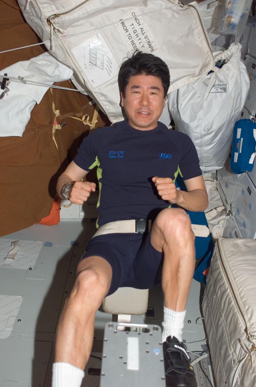 S123-E-006703 (16 March 2008) --- Japan Aerospace Exploration Agency (JAXA) astronaut Takao Doi, STS-123 mission specialist, exercises on a bicycle ergometer on the middeck of the Space Shuttle Endeavour while docked with the International Space Station.