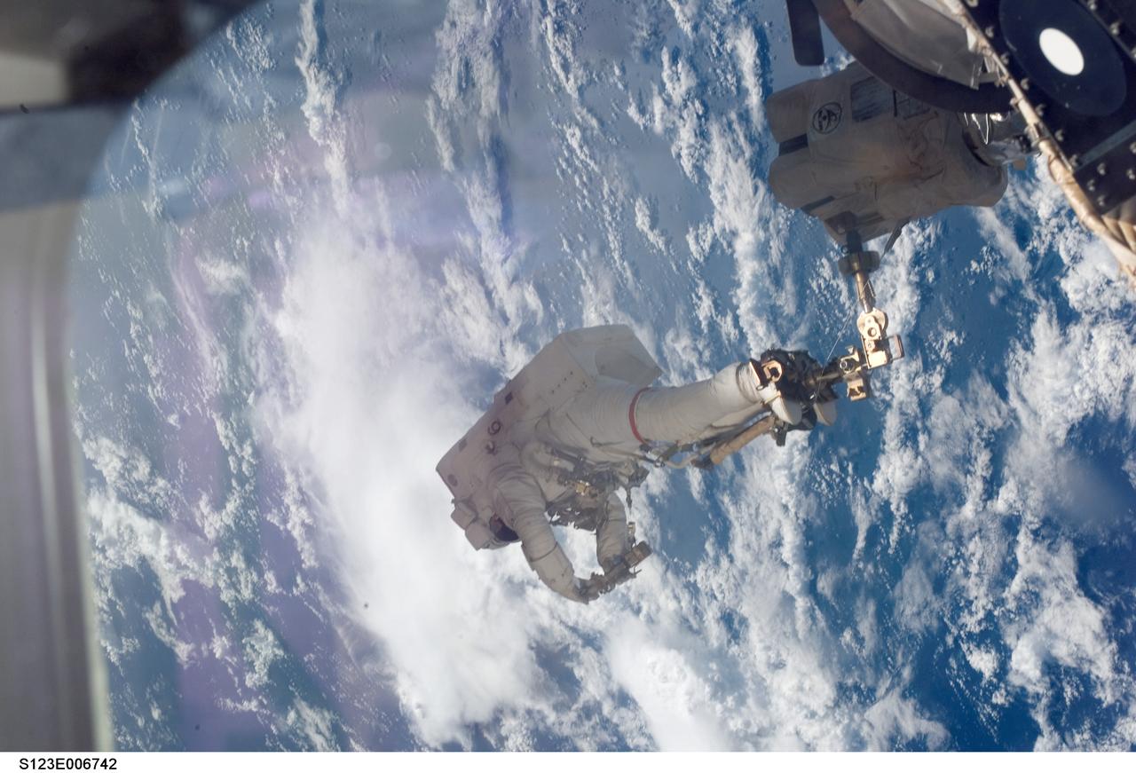 S123-E-006742 (17/18 March 2008) --- Anchored to a Canadarm2 mobile foot restraint, astronaut Rick Linnehan, STS-123 mission specialist, participates in the mission's third scheduled session of extravehicular activity (EVA) as construction and maintenance continue on the International Space Station. During the 6-hour, 53-minute spacewalk, Linnehan and astronaut Robert L. Behnken (out of frame), mission specialist, installed a spare-parts platform and tool-handling assembly for Dextre, also known as the Special Purpose Dextrous Manipulator (SPDM). Among other tasks, they also checked out and calibrated Dextre's end effector and attached critical spare parts to an external stowage platform. The new robotic system is scheduled to be activated on a power and data grapple fixture located on the Destiny laboratory on flight day nine.