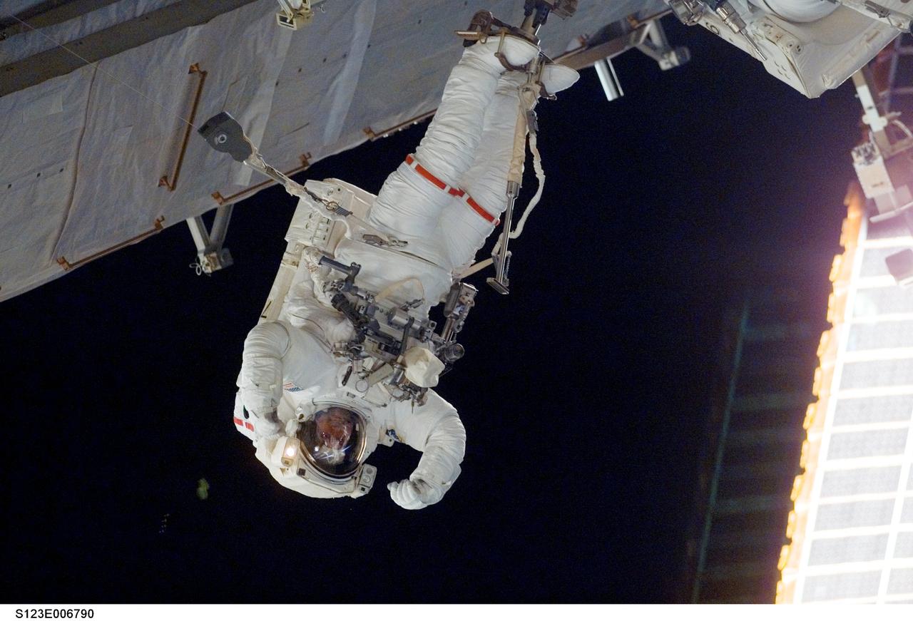 S123-E-006790 (15/16 March 2008) --- Astronauts Mike Foreman and Rick Linnehan (partially out of frame), both STS-123 mission specialists, participate in the mission's second scheduled session of extravehicular activity (EVA) as construction and maintenance continue on the International Space Station. During the 7-hour, 8-minute spacewalk, Linnehan and Foreman, assembled the stick-figure-shaped Dextre, also known as the Special Purpose Dextrous Manipulator (SPDM), a task that included attaching its two arms. Designed for station maintenance and service, Dextre is capable of sensing forces and movement of objects it is manipulating. It can automatically compensate for those forces and movements to ensure an object is moved smoothly. Dextre is the final element of the station's Mobile Servicing System.
