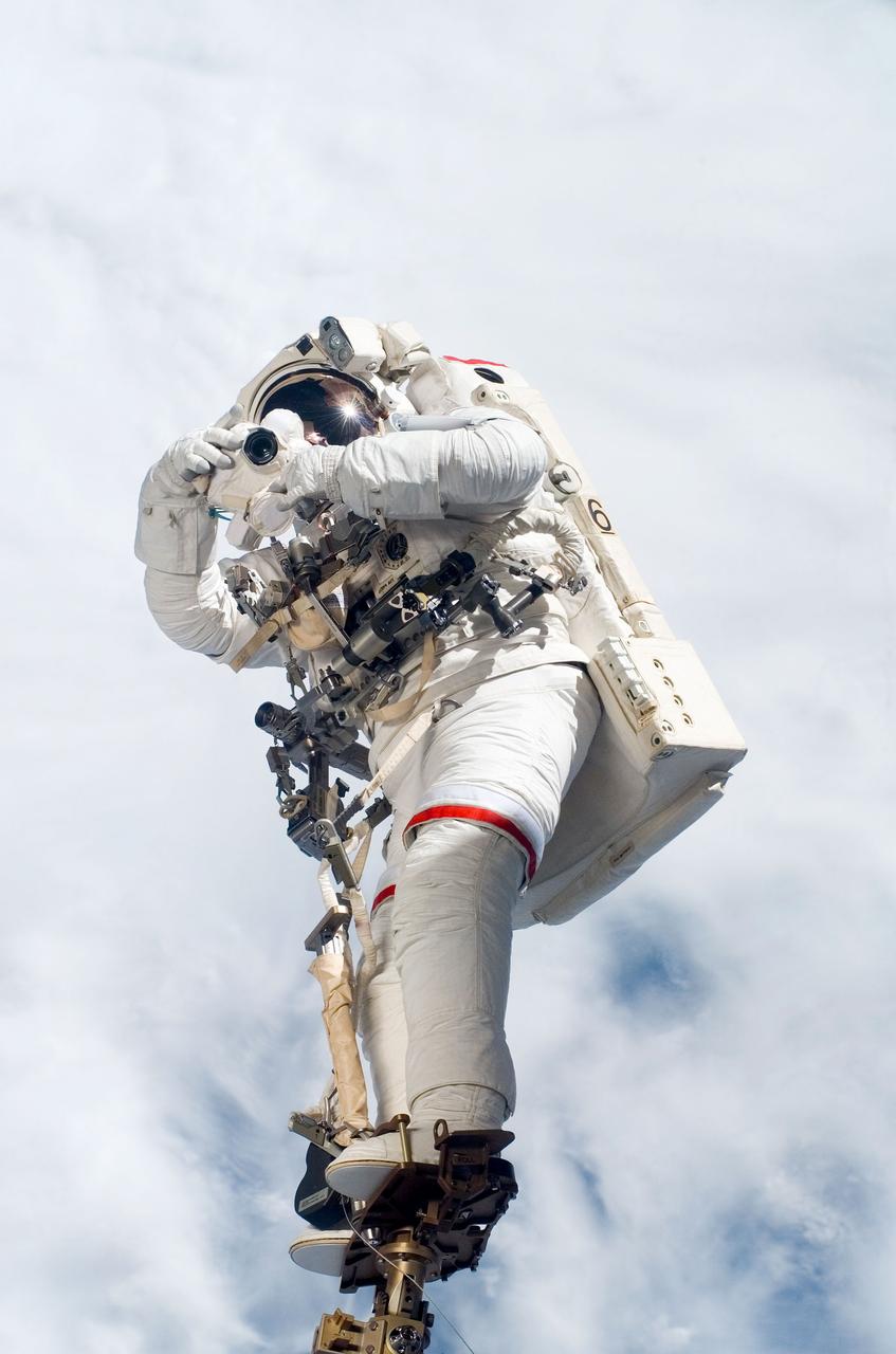 S123-E-007021 (17/18 March 2008) --- Anchored to a Canadarm2 mobile foot restraint, astronaut Rick Linnehan, STS-123 mission specialist, participates in the mission's third scheduled session of extravehicular activity (EVA) as construction and maintenance continue on the International Space Station. During the 6-hour, 53-minute spacewalk, Linnehan and astronaut Robert L. Behnken (out of frame), mission specialist, installed a spare-parts platform and tool-handling assembly for Dextre, also known as the Special Purpose Dextrous Manipulator (SPDM). Among other tasks, they also checked out and calibrated Dextre's end effector and attached critical spare parts to an external stowage platform. The new robotic system is scheduled to be activated on a power and data grapple fixture located on the Destiny laboratory on flight day nine.