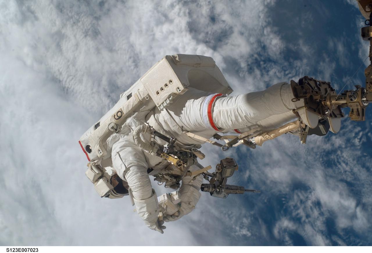 S123-E-007023 (17/18 March 2008) --- Anchored to a Canadarm2 mobile foot restraint, astronaut Rick Linnehan, STS-123 mission specialist, participates in the mission's third scheduled session of extravehicular activity (EVA) as construction and maintenance continue on the International Space Station. During the 6-hour, 53-minute spacewalk, Linnehan and astronaut Robert L. Behnken (out of frame), mission specialist, installed a spare-parts platform and tool-handling assembly for Dextre, also known as the Special Purpose Dextrous Manipulator (SPDM). Among other tasks, they also checked out and calibrated Dextre's end effector and attached critical spare parts to an external stowage platform. The new robotic system is scheduled to be activated on a power and data grapple fixture located on the Destiny laboratory on flight day nine.