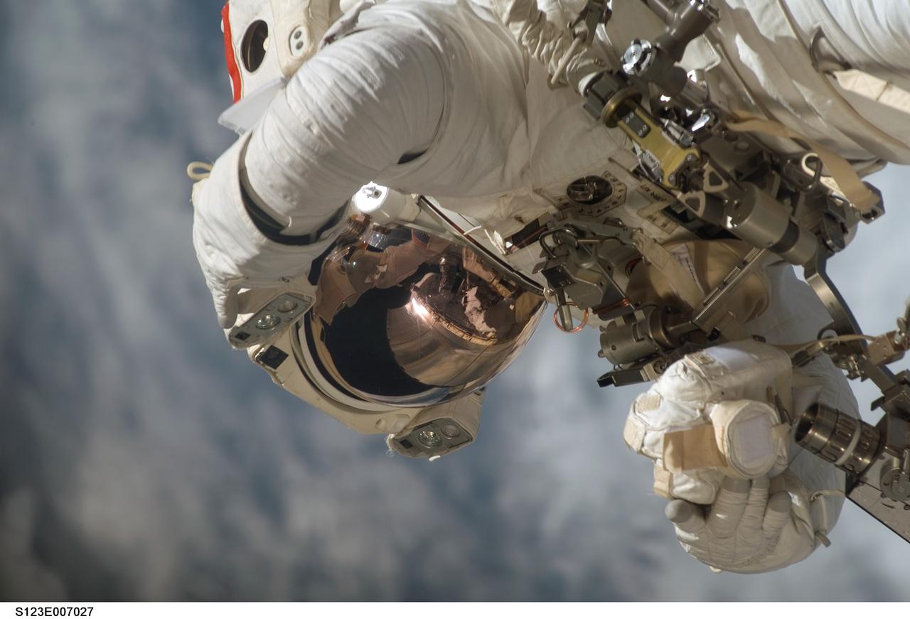 S123-E-007027 (17/18 March 2008) --- Astronaut Rick Linnehan, STS-123 mission specialist, participates in the mission's third scheduled session of extravehicular activity (EVA) as construction and maintenance continue on the International Space Station. During the 6-hour, 53-minute spacewalk, Linnehan and astronaut Robert L. Behnken (out of frame), mission specialist, installed a spare-parts platform and tool-handling assembly for Dextre, also known as the Special Purpose Dextrous Manipulator (SPDM). Among other tasks, they also checked out and calibrated Dextre's end effector and attached critical spare parts to an external stowage platform. The new robotic system is scheduled to be activated on a power and data grapple fixture located on the Destiny laboratory on flight day nine.