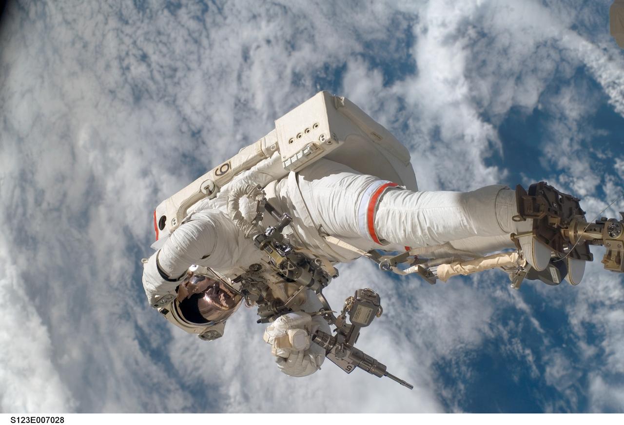 S123-E-007028 (17/18 March 2008) --- Anchored to a Canadarm2 mobile foot restraint, astronaut Rick Linnehan, STS-123 mission specialist, participates in the mission's third scheduled session of extravehicular activity (EVA) as construction and maintenance continue on the International Space Station. During the 6-hour, 53-minute spacewalk, Linnehan and astronaut Robert L. Behnken (out of frame), mission specialist, installed a spare-parts platform and tool-handling assembly for Dextre, also known as the Special Purpose Dextrous Manipulator (SPDM). Among other tasks, they also checked out and calibrated Dextre's end effector and attached critical spare parts to an external stowage platform. The new robotic system is scheduled to be activated on a power and data grapple fixture located on the Destiny laboratory on flight day nine.