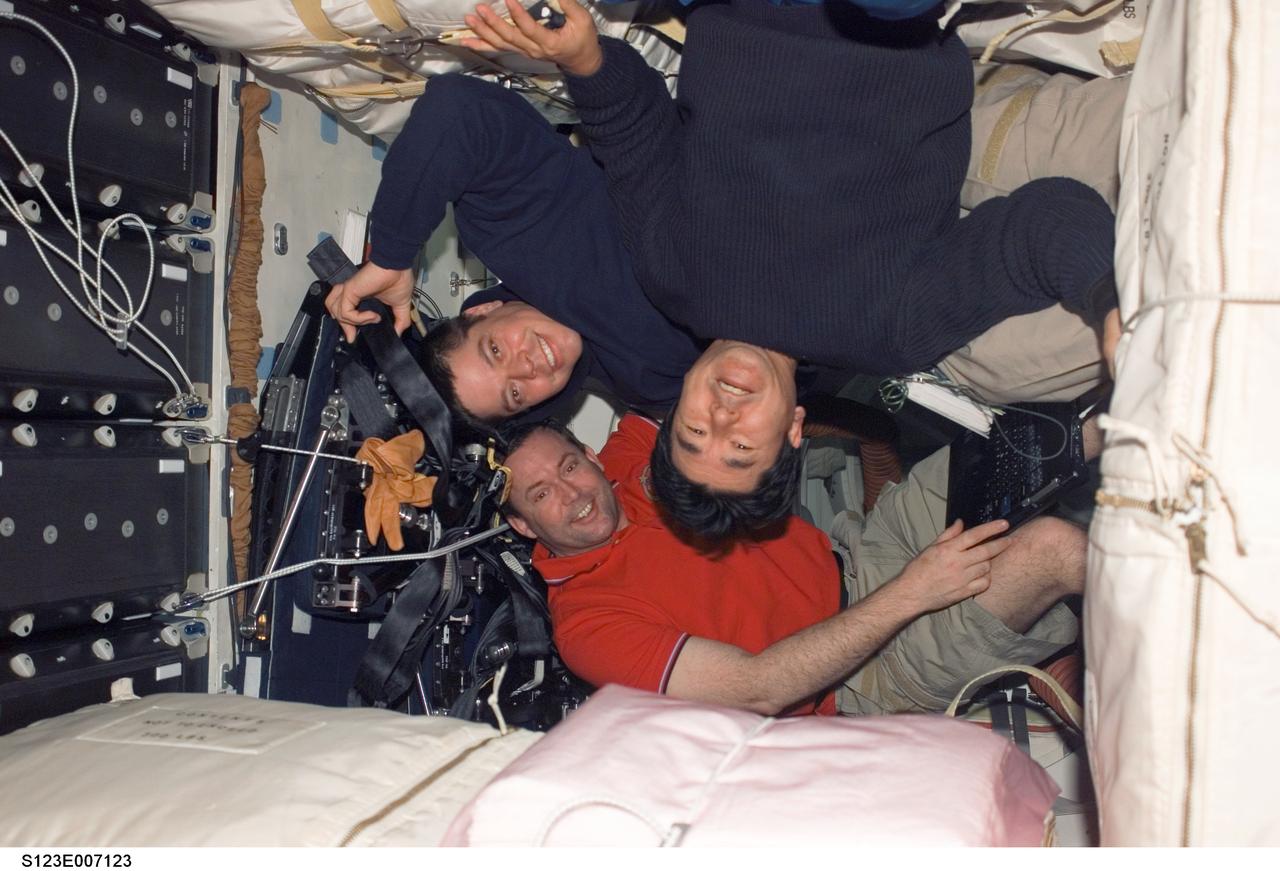 S123-E-007123 (18 March 2008) --- Japan Aerospace Exploration Agency (JAXA) astronaut Takao Doi (top right), NASA astronauts Robert L. Behnken (top left) and Mike Foreman, all STS-123 mission specialists, are pictured on the middeck of Space Shuttle Endeavour while docked with the International Space Station.