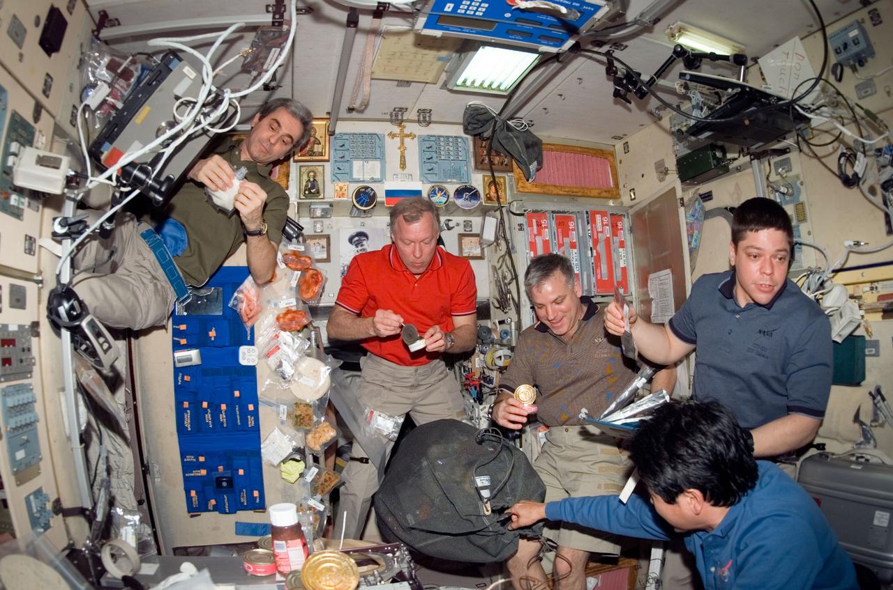 S123-E-007231 (19 March 2008) --- The STS-123 and Expedition 16 crewmembers share a meal near the galley in the Zvezda Service Module of the International Space Station while Space Shuttle Endeavour is docked with the station. Pictured (from the left) are European Space Agency (ESA) astronaut Leopold Eyharts, STS-123 mission specialist; NASA astronauts Dominic Gorie, STS-123 commander; Gregory H. Johnson, STS-123 pilot; Robert L. Behnken and Japan Aerospace Exploration Agency (JAXA) astronaut Takao Doi, both STS-123 mission specialists.