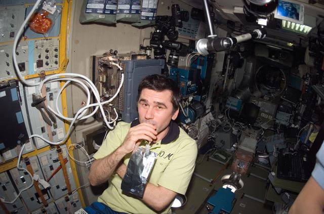 NASA image: Malenchenko enjoys a drink in the SM during Joint Operations