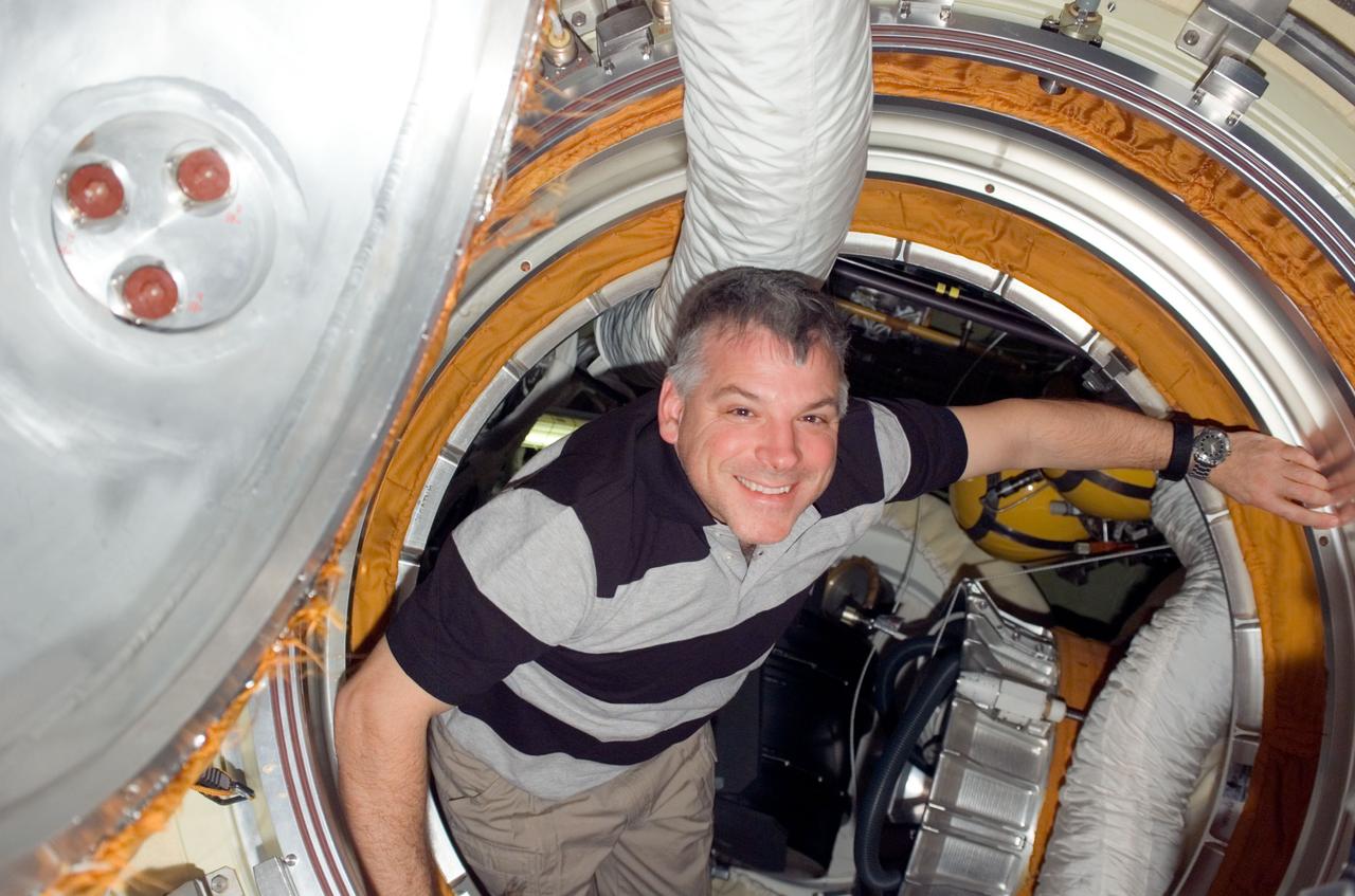 S123-E-008341 (21 March 2008) --- Astronaut Gregory H. Johnson, STS-123 pilot, is pictured in the Pirs Docking Compartment of the International Space Station while Space Shuttle Endeavour is docked with the station.