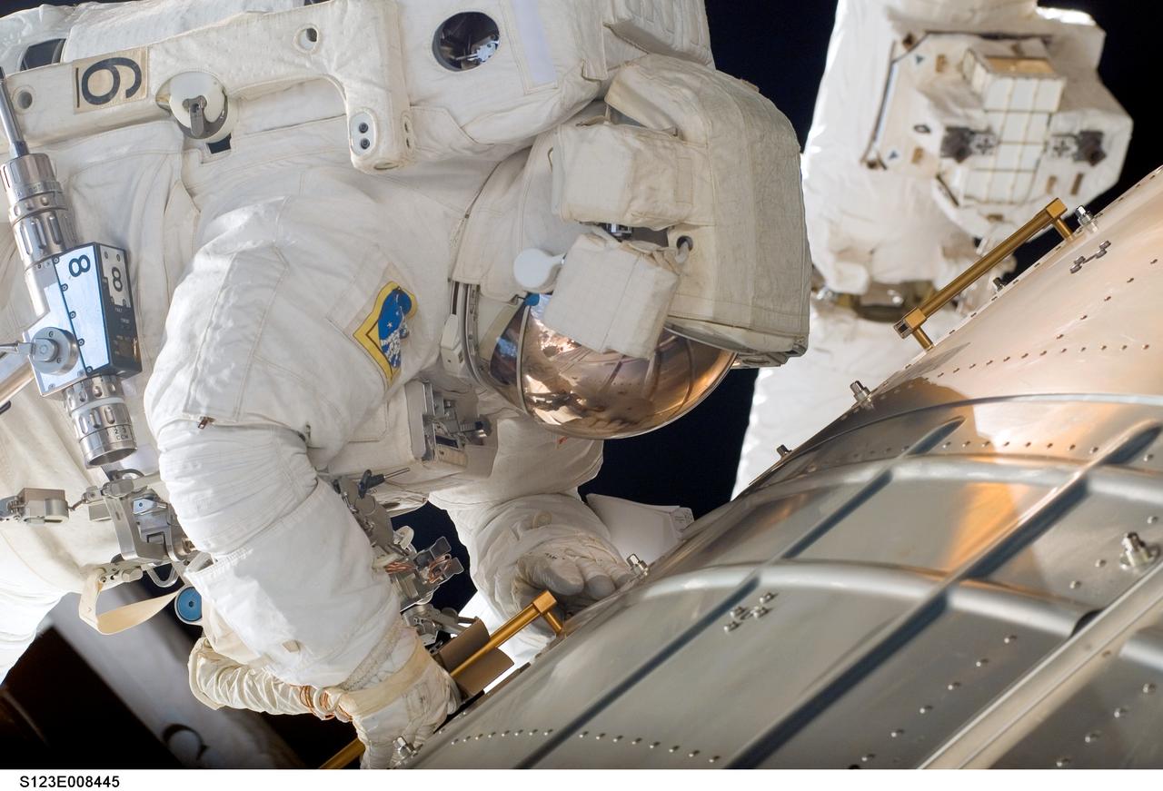 S123-E-008445 (23 March 2008) --- Astronaut Robert L. Behnken, STS-123 mission specialist, working with astronaut Mike Foreman (out of frame), nears the completion of the fifth and final spacewalk involving the STS-123/Expedition 16 crewmembers