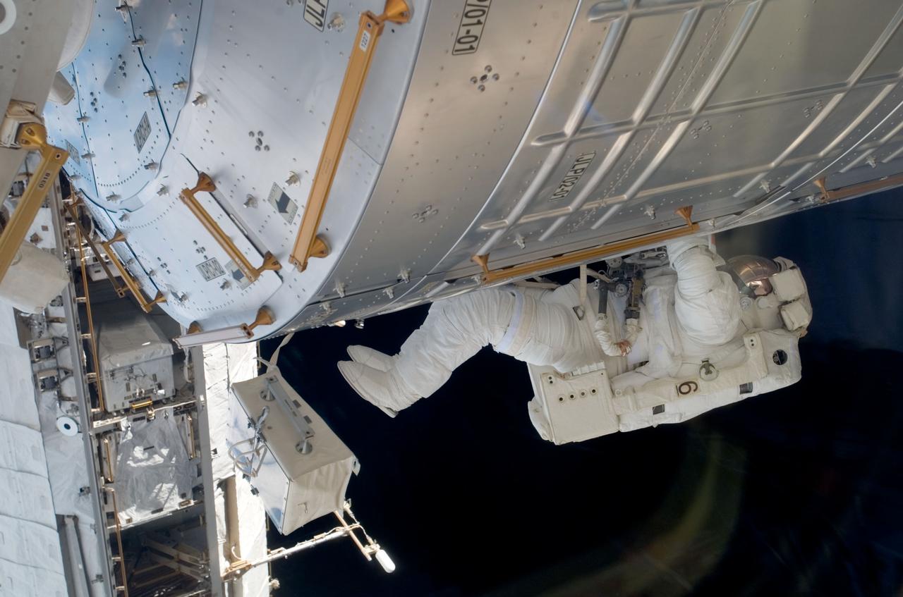 S123-E-008575 (23 March 2008) --- Astronaut Robert L. Behnken, STS-123 mission specialist, working with astronaut Mike Foreman (out of frame), assumes an insect-like position not so easily accomplished in Earth's gravity. The two were nearing the completion of the fifth and final spacewalk involving the STS-123/Expedition 16 crewmembers.