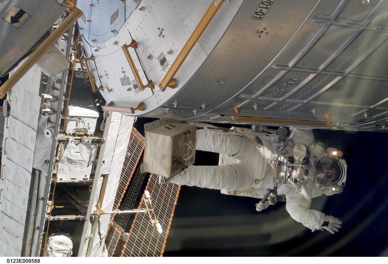 S123-E-008588 (23 March 2008) --- Astronaut Robert L. Behnken, STS-123 mission specialist, while holding a handrail on the Kibo Logistics Module, waves to members of the Endeavour and International Space Station crews working inside the orbital complex during the fifth and final spacewalk involving the STS-123/Expedition 16 personnel.