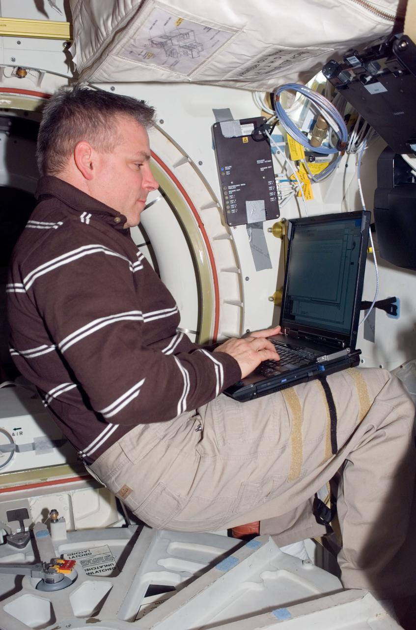 S123-E-008728 (22 March 2008) --- Astronaut Gregory H. Johnson, STS-123 pilot, uses a computer on the middeck of Space Shuttle Endeavour while docked with the International Space Station.