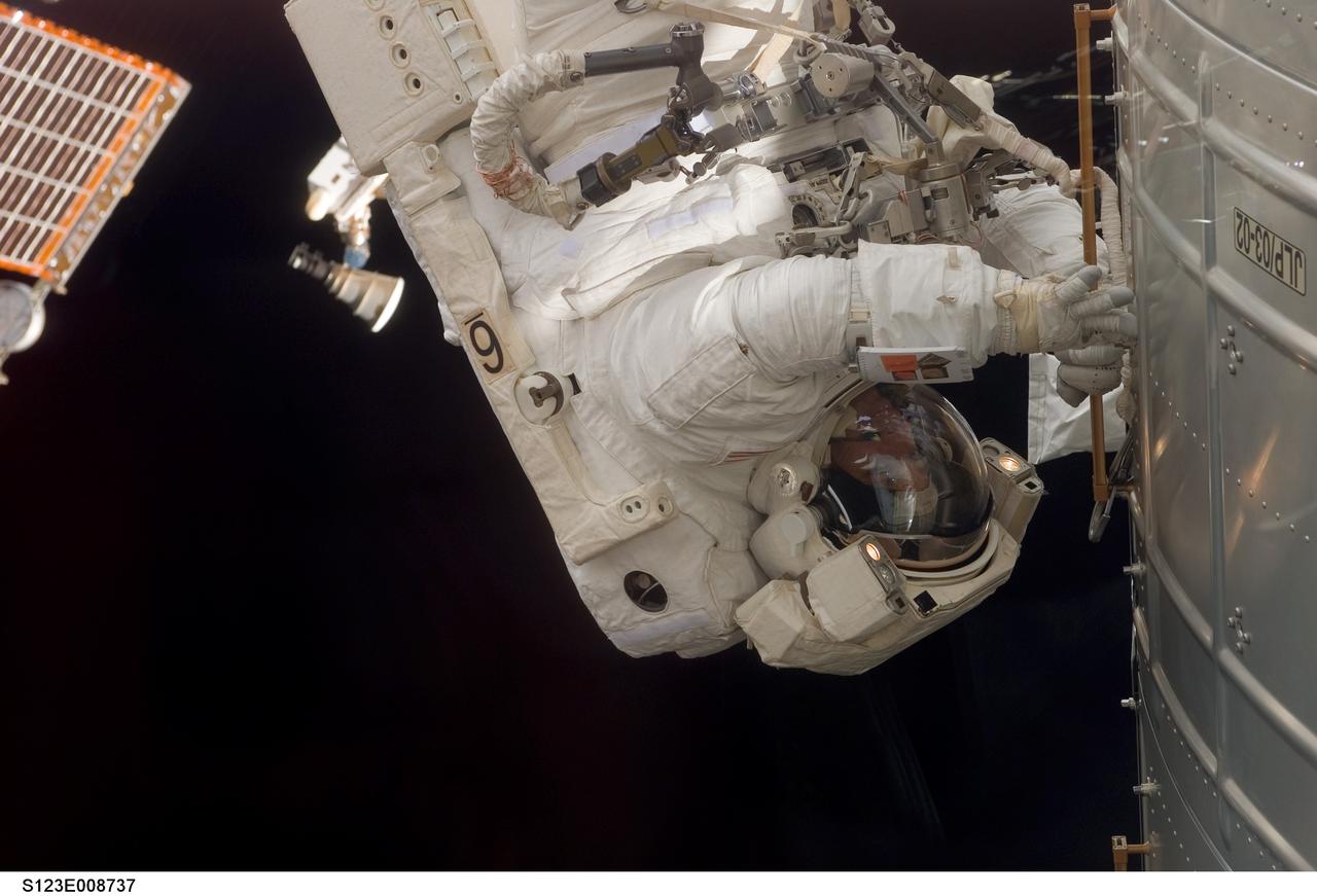 S123-E-008737 (22 March 2008) --- Astronaut Robert L. Behnken, STS-123 mission specialist, participates in the mission's fifth and final scheduled session of extravehicular activity (EVA) as construction and maintenance continue on the International Space Station. During the spacewalk, Behnken and astronaut Mike Foreman (out of frame), mission specialist, attached the shuttle's Orbiter Boom Sensor System (OBSS) to the S1 truss on the station, released launch locks on two of the Harmony module's common berthing mechanisms and install trunnion covers on the Japanese Logistics Module -- Pressurized Section. The spacewalkers also performed other tasks including an inspection of the starboard Solar Alpha Rotary Joint (SARJ) and installed the Materials International Space Station Experiment 6 (MISSE-6) on the outside of the European Space Agency's Columbus laboratory.