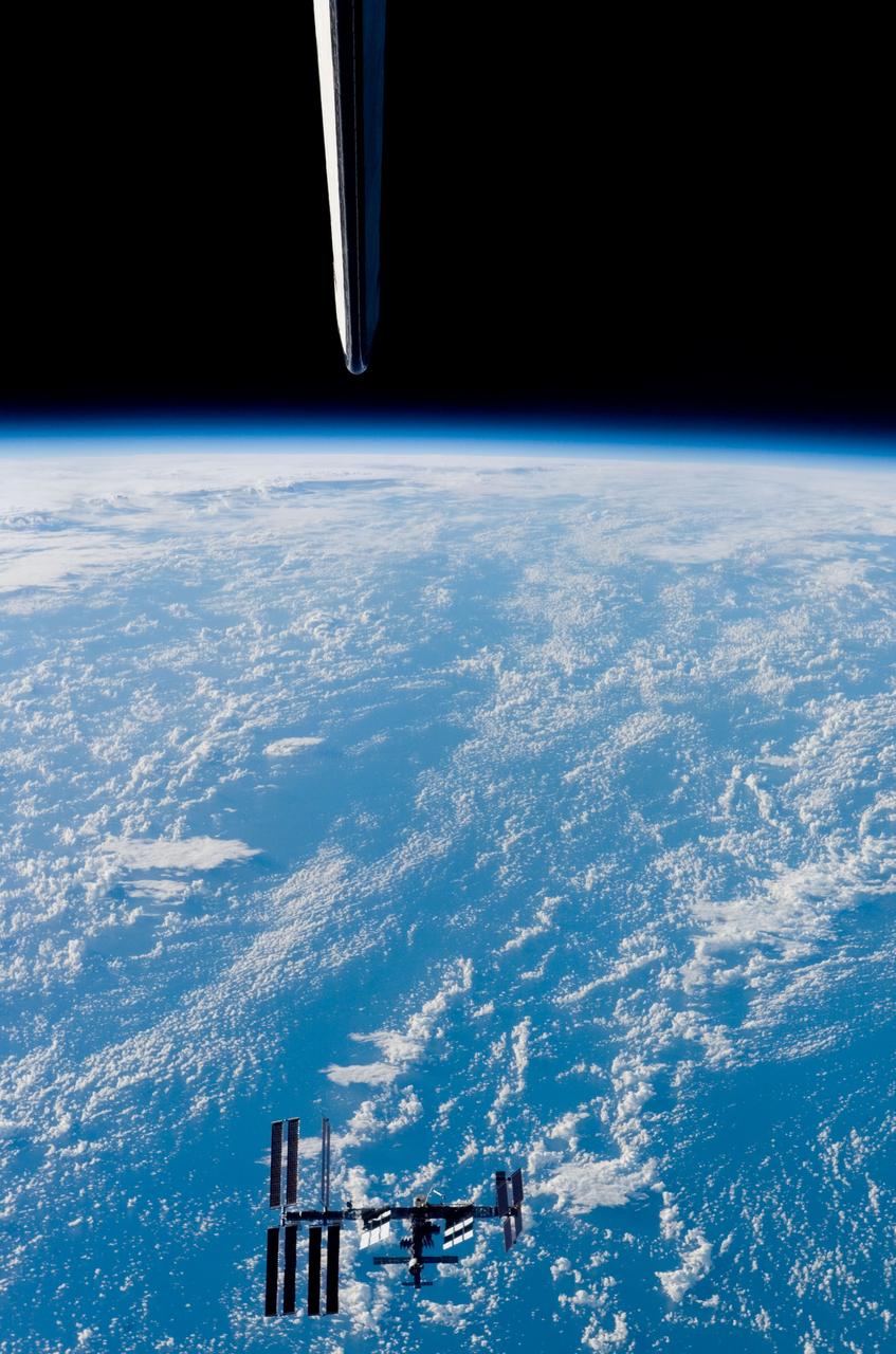 S123-E-009202 (24 March 2008) --- Backdropped by Earth's horizon and the blackness of space, the International Space Station appears small from the point of view of the Space Shuttle Endeavour as the two spacecraft carry out their relative separation. Endeavour's vertical stabilizer is seen in this image photographed by a STS-123 crewmember onboard the shuttle. Earlier the STS-123 and Expedition 16 crews concluded 12 days of cooperative work onboard the shuttle and station. Undocking of the two spacecraft occurred at 7:25 p.m. (CDT) on March 24, 2008.