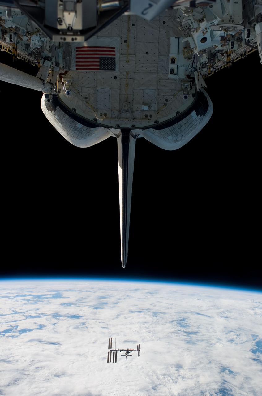 S123-E-009210 (24 March 2008) --- Backdropped by Earth's horizon and the blackness of space, the International Space Station appears very small from the point of view of the Space Shuttle Endeavour as the two spacecraft carry out their relative separation. Endeavour's vertical stabilizer, orbital maneuvering system (OMS) pods and payload bay are seen in this image photographed by an STS-123 crewmember onboard the shuttle. Earlier the STS-123 and Expedition 16 crews concluded 12 days of cooperative work onboard the shuttle and station. Undocking of the two spacecraft occurred at 7:25 p.m. (CDT) on March 24, 2008.