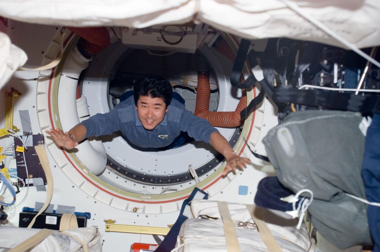 S123-E-009791 (24 March 2008) --- Japan Aerospace Exploration Agency (JAXA) astronaut Takao Doi, STS-123 mission specialist, floats through a hatch on Space Shuttle Endeavour while docked with the International Space Station.