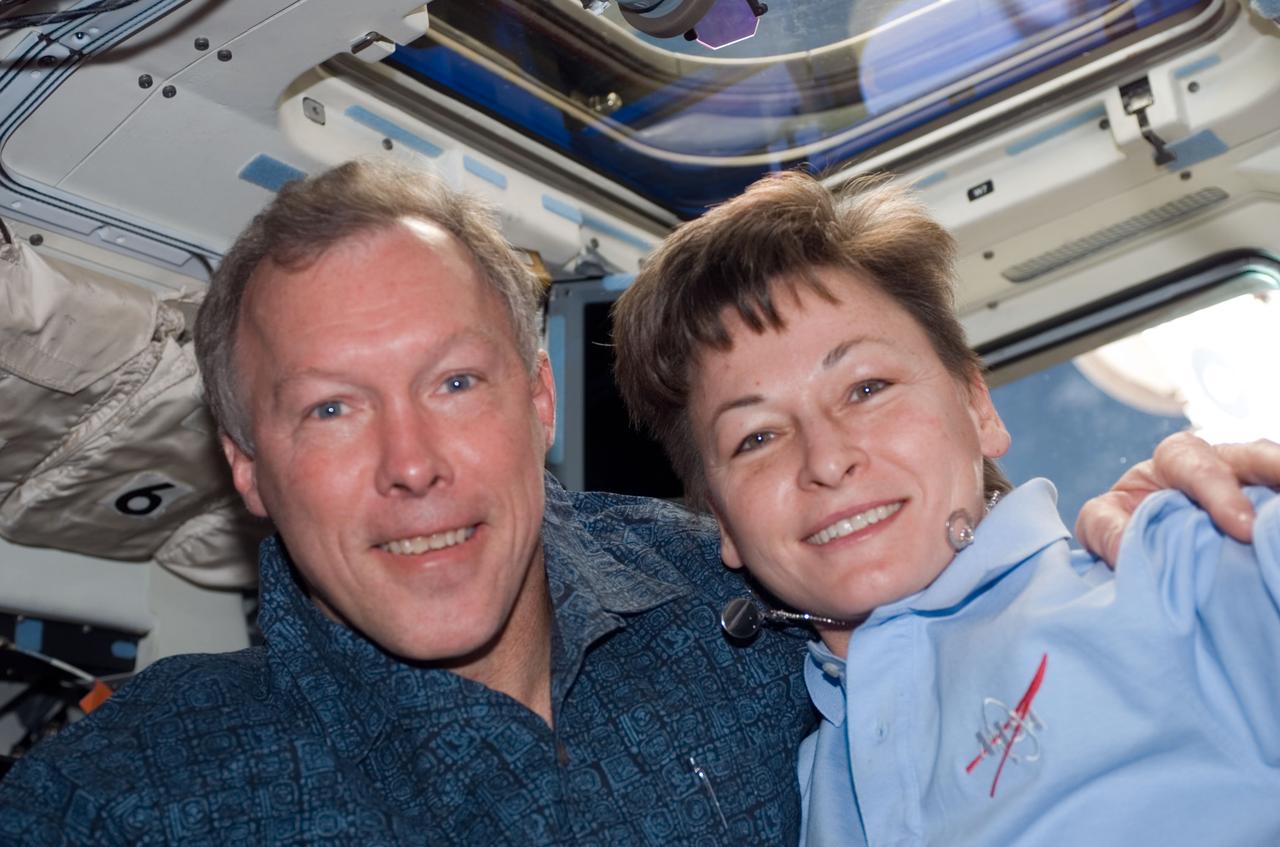 S123-E-009868 (24 March 2008) --- Astronauts Dominic Gorie, STS-123 commander, and Peggy Whitson, Expedition 16 commander, take a moment to pose for a photo on the aft flight deck of Space Shuttle Endeavour while docked with the International Space Station.