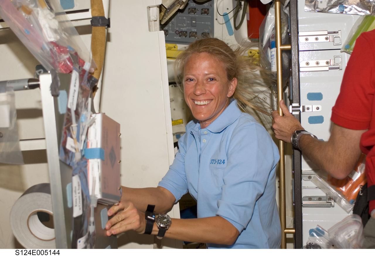S124-E-005144 (1 June 2008) --- Astronaut Karen Nyberg, STS-124 mission specialist, takes a moment for a photo while working on the middeck of Space Shuttle Discovery during flight day two activities.